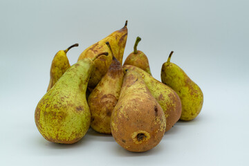pile of ripe pears on white background