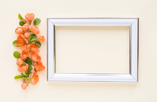beautiful flower arrangement. Bright orange flowers, empty photo frame for text on a light pastel background. Wedding. birthday. Valentine's Day. mothers Day. top view, copy space