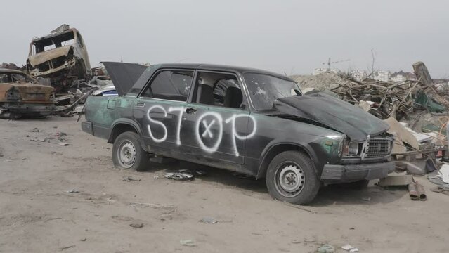 Cemetery of destroyed cars after the evacuation of the inhabitants of the city of Bucha. Ukraine. Grod Bucha. War in Ukraine. Shot cars.