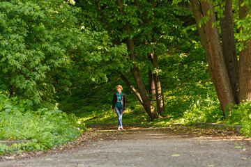 beautiful girl walking in summer park