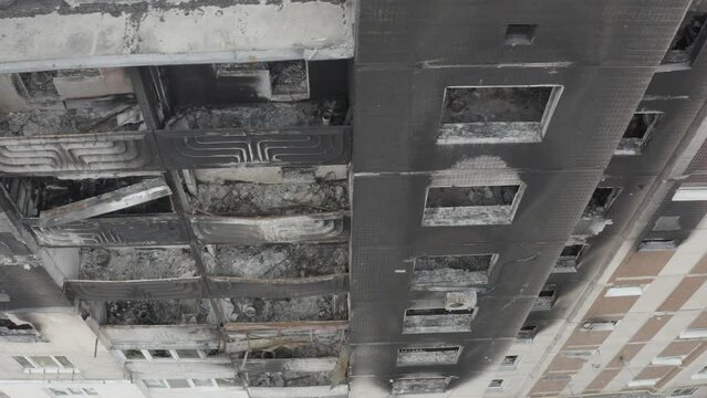 Damaged residential building in the Bucha city, Kyiv region during the fighting after the Russian attack on Ukraine. Russian-Ukrainian war. Aerial. Fire in the house. 