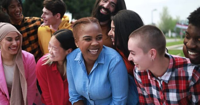 Group of young multiracial people having fun together in the city 