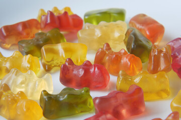 gummy candies on a plate on yellow background .