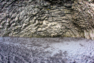 Basalt columns on a black reynisfjara beach in Iceland