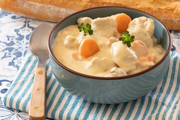 veal meat cooked with mushrooms and carrots in a dish