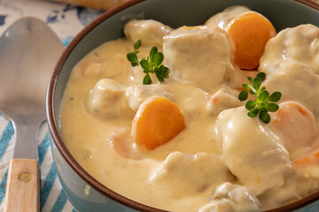 veal meat cooked with mushrooms and carrots in a dish