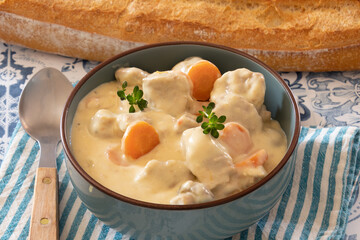 veal meat cooked with mushrooms and carrots in a dish
