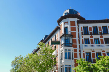 Fototapeta na wymiar Corner of vibrant modernist building with metallic balconies in Chueca district downtown Madrid, Spain