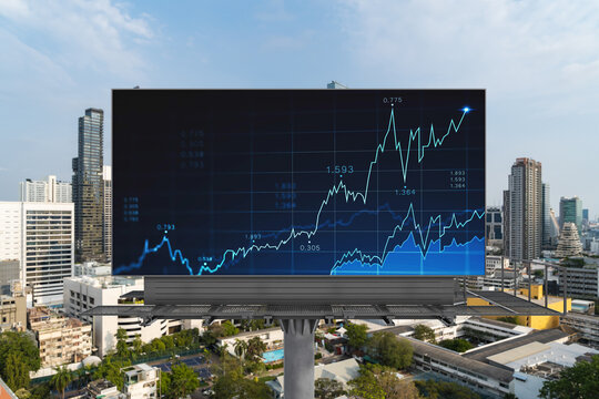 Forex and stock market chart hologram on road billboard over panorama city view of Bangkok. The financial center in Southeast Asia. The concept of international trading.