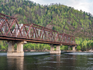 Old abandoned railway bridge across the river
