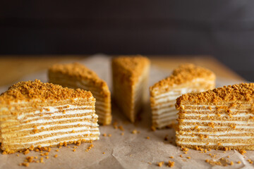 Sugar dessert on table. Baked cake with cream. Many pieces of cake