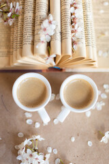 Cups of coffee on wooden background with fresh flowers in bloom. Art decoration. Breakfast concept
