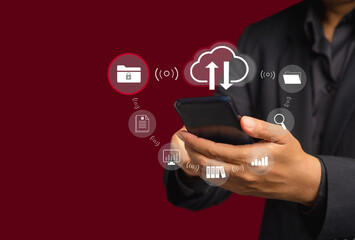 Businessman using a smartphone login to cloud computing on the virtual screen while standing on a gray background