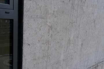 concrete gray wall of an architectural building, building material, texture for a designer