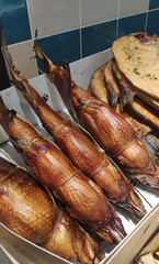 Smoked sea bass on the counter. Fish market.