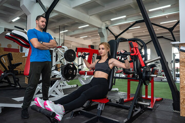 Fototapeta na wymiar couple young slim people work out together in the gym
