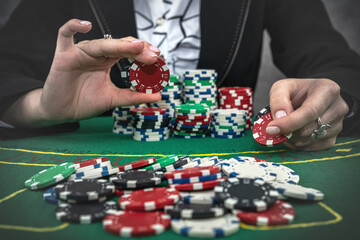 Fototapeta na wymiar woman raising bets in poker game, lucky