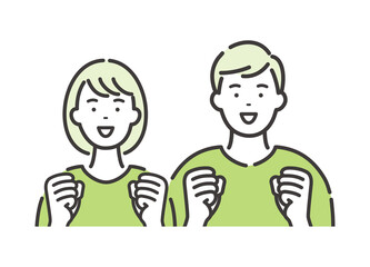 若い男女のカップル　両手を握りしめて喜ぶポーズ