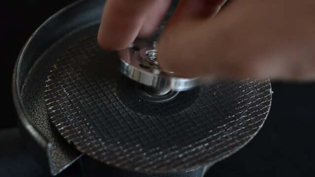 The master installs the cutting wheel in the angle grinder	
