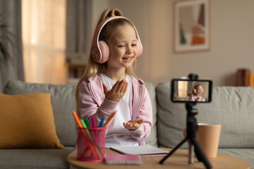 Little Girl Making Video For Blog Talking To Cellphone Indoor