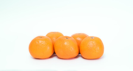 Five ripe juicy tangerines isolated on white background. Healthy food.
