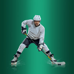 Professional ice hockey player hitting puck for winning goal in action on gradient multicolored...