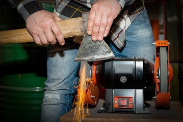 The process of sharpening an ax with the release of a large number of bright sparks
