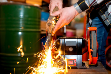 The process of sharpening an ax with the release of a large number of bright sparks