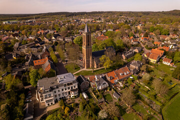 Dutch painterly picturesque village of Amerongen showing the church tower in the town center rising...