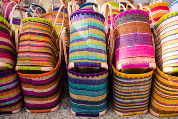 Colorful handcrafted straw baskets sold at a farmers market in Lourmarin, Provence, France - obrazy, fototapety, plakaty