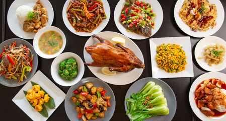 Fototapeta na wymiar Top view food platter combo set of traditional Cantonese yum-cha Asian gourmet cuisine meal food dish on the white serving plate on the table, includes dishes of duck, pork, fish, chicken, vegetables