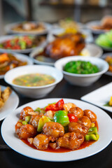 Food platter combo set of traditional Cantonese yum-cha Asian gourmet cuisine meal food dish on the white serving plate on the table, includes dishes of duck, sweet sour pork, fish, chicken