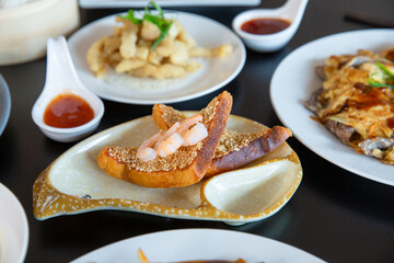 Food platter combo set of traditional Cantonese yum-cha Asian gourmet cuisine meal food dish on the white serving plate on the table, includes dishes of duck, pork, fish, chicken, prawn shrimp toast