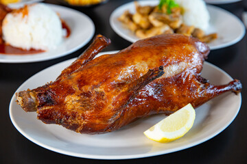 Food platter combo set of traditional Cantonese yum-cha Asian gourmet cuisine meal food dish on the white serving plate on the table, includes dishes of roast Peking duck, pork, fish, chicken