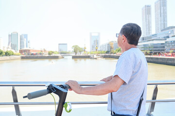 Hispanic senior man sightseeing with his electric scooter in Buenos Aires