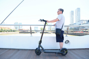 Hispanic senior man sightseeing with his electric scooter in Buenos Aires