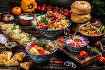 Uzbek and Central Asia cuisine concept. Assorted Uzbek food pilaf samsa lagman manti shurpa Uzbek restaurant concept Uzbek food. Food recipe background.