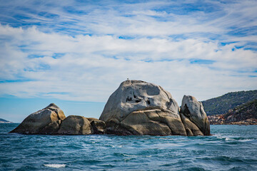 Fototapeta premium Isolated island rock seascape in Cruising tour view in the Bass Strait at Wilson Promontory Victoria Australia, with blue sea and sky