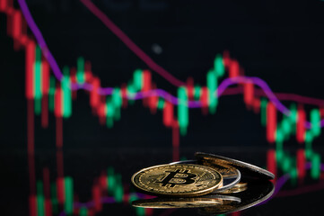 Cryptocurrency. Bitcoin Stock Growth.Bitcoin gold coin and defocused chart background. Virtual cryptocurrency concept. Investing in virtual assets. Investment platform with charts and bitcoin coin.