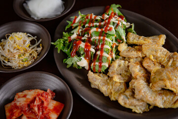 Korean Grilled BBQ combo sets with beef pancake with salad on the traditional grill table, and pickle dishes