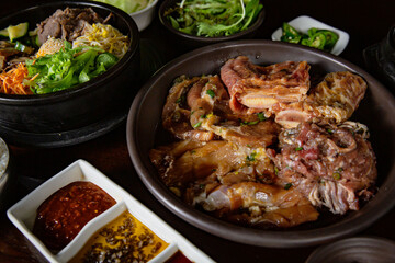 Korean Grilled BBQ combo with marinated beef pork meat set on the traditional grill table, with...