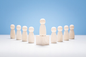 Leadership, wooden business team with one person standing out from the crowd