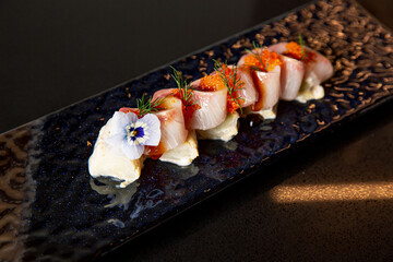Kaiseki sushi platter combo set on the serving board in the fine dining Japanese restaurant,...