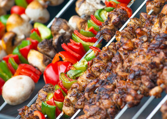 Skewered meat and vegetables being grilled.