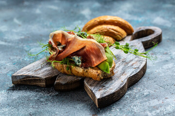 Variety of aperitifs Croissant sandwiches with jamon ham serrano paleta iberica, blue cheese,...