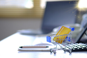 Shopping cart with credit card and laptop