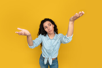 Pensive young woman comparing variants, making scales with empty hands