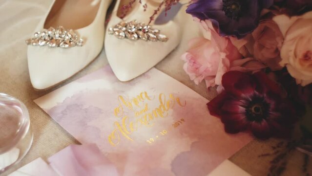Close-up wedding accessories of the bride slow motion, wedding bouquet, bride's shoes, wedding rings. Morning of the bride. Wedding accessories. 