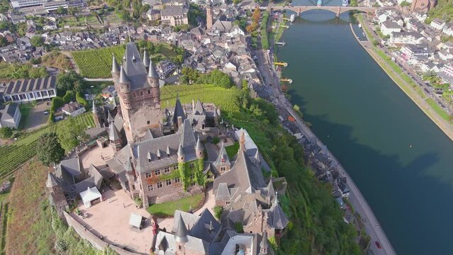 Cochem, Germany: Aerial view of Cochem Imperial Castle (Reichsburg Cochem), medieval hill-top castle with quadrangular tower, lush valley of river Moselle - landscape panorama of Europe from above