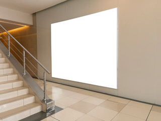 Blank billboard mock up on the wall beside the escalator at shopping mall. Advertising concept - stock photo